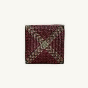 Handwoven Krajood seagrass lidded box with dark multicolor geometric pattern in red, green and yellow, approx. 28 × 28 × 8 cm, handmade in Thailand - So Rare Pieces.