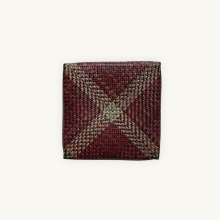 Handwoven Krajood seagrass lidded box with dark multicolor geometric pattern in red, green and yellow, approx. 28 × 28 × 8 cm, handmade in Thailand - So Rare Pieces.