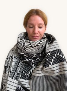 Model wears patterned scarf by So Rare Pieces