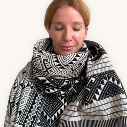 Model wears patterned scarf by So Rare Pieces