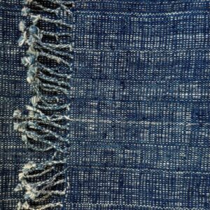 Handspun cotton in natural indigo tones, hand-woven in Northeastern Thailand by women-led weaving groups in the Khon Kaen region. Plant-dyed with fermented indigo leaves. 40 × 200 cm.