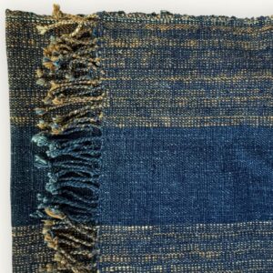 Handspun cotton in natural indigo tones, hand-woven in Northeastern Thailand by women-led weaving groups. Plant-dyed with fermented indigo leaves. 40 × 200 cm.
