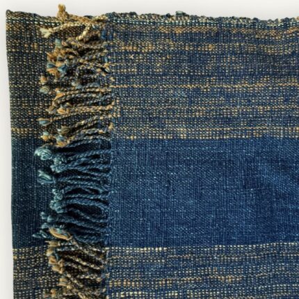 Handspun cotton in natural indigo tones, hand-woven in Northeastern Thailand by women-led weaving groups. Plant-dyed with fermented indigo leaves. 40 × 200 cm.