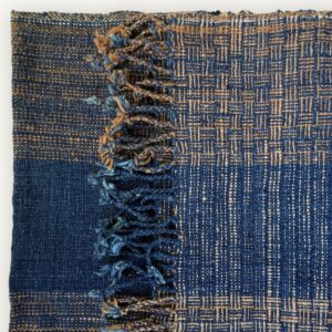 Handspun cotton in natural indigo tones, hand-woven in Northeastern Thailand by women-led weaving groups. Plant-dyed with fermented indigo leaves. 40 × 200 cm.