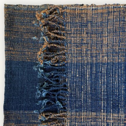 Handspun cotton in natural indigo tones, hand-woven in Northeastern Thailand by women-led weaving groups. Plant-dyed with fermented indigo leaves. 40 × 200 cm.
