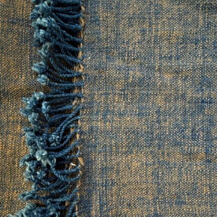 Handspun cotton in warm ochre and deep indigo, hand-woven in Northeastern Thailand by women-led weaving groups in Thailand. Plant-dyed. 80 × 200 cm.