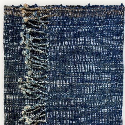 Handspun cotton in natural indigo tones, hand-woven in Northeastern Thailand by women-led weaving groups in the Khon Kaen region. Plant-dyed with fermented indigo leaves. 40 × 200 cm.
