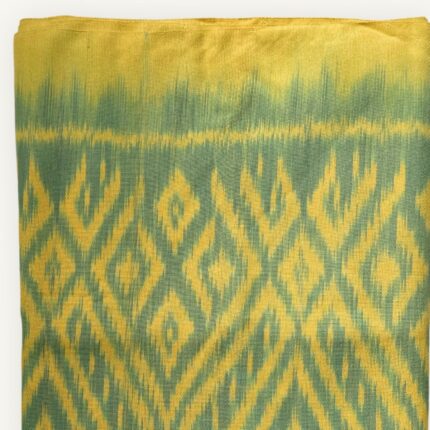 Handwoven Mudmee Ikat cotton scarf in lime yellow and soft green, blurred pattern edges, Thailand