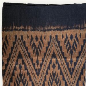 Handwoven Mudmee Ikat cotton scarf in earthy natural tones, blurred pattern edges, Thailand