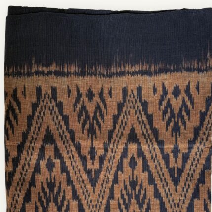 Handwoven Mudmee Ikat cotton scarf in earthy natural tones, blurred pattern edges, Thailand