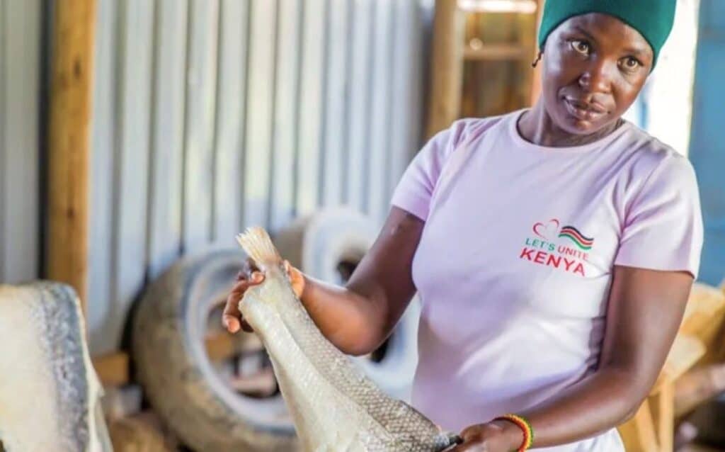 Insight into Ambani's Workshop: female worker presents nile perch.